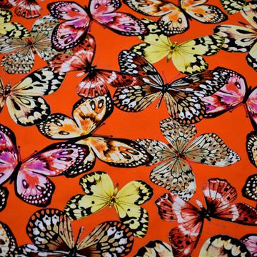 Bombažni jersey - pisani metulji na oranžni osnovi